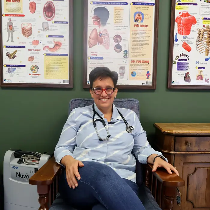 Dr. Carla Els seated in the consulting room